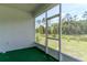 View from the enclosed patio showing the pond and backyard at 6300 Dolostone Dr, Lakeland, FL 33811