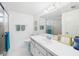 Bright bathroom showcasing clean white fixtures, including a vanity, toilet, and well-lit mirror at 700 Mirror Nw Ter # 702, Winter Haven, FL 33881