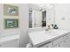 Bright bathroom with white vanity, framed art, and a large mirror at 700 Mirror Nw Ter # 702, Winter Haven, FL 33881