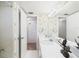 Bathroom featuring floral wallpaper, a well-lit vanity with white countertop, and a shower with tile at 700 Mirror Nw Ter # 702, Winter Haven, FL 33881
