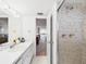 Bathroom featuring tiled shower and view to bedroom with water view at 700 Mirror Nw Ter # 702, Winter Haven, FL 33881