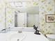 Charming bathroom with vintage wallpaper, a spacious vanity, and a clear view of the shower area at 700 Mirror Nw Ter # 702, Winter Haven, FL 33881