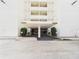 Building entrance with covered entrance and well maintained landscaping at 700 Mirror Nw Ter # 702, Winter Haven, FL 33881