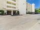 Exterior of building with covered parking and well maintained landscaping at 700 Mirror Nw Ter # 702, Winter Haven, FL 33881