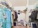 Walk-in closet providing ample storage with clothes and shelving at 700 Mirror Nw Ter # 702, Winter Haven, FL 33881