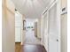 Hallway entrance features a closet and views into the living room and kitchen at 700 Mirror Nw Ter # 702, Winter Haven, FL 33881