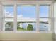 Bright room featuring large windows with beautiful lake views, inviting natural light at 700 Mirror Nw Ter # 702, Winter Haven, FL 33881