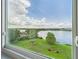 Stunning lake views seen from a large window showcasing the outdoor scenery at 700 Mirror Nw Ter # 702, Winter Haven, FL 33881