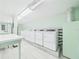 Clean, well-maintained laundry room with multiple washing machines and a folding area at 700 Mirror Nw Ter # 702, Winter Haven, FL 33881