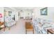 Inviting living room featuring comfortable floral furniture and a well-lit dining area at 700 Mirror Nw Ter # 702, Winter Haven, FL 33881