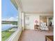 Comfortable living room features lake views, carpet flooring, and an inviting atmosphere at 700 Mirror Nw Ter # 702, Winter Haven, FL 33881