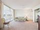 Comfortable living room with balcony access and cozy floral-patterned sofa at 700 Mirror Nw Ter # 702, Winter Haven, FL 33881