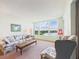 Cozy living room with scenic lake views, comfortable seating, and serene atmosphere at 700 Mirror Nw Ter # 702, Winter Haven, FL 33881