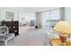 Open living space with balcony access features floral furniture at 700 Mirror Nw Ter # 702, Winter Haven, FL 33881