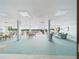 Spacious lounge featuring tiled floor, multiple sitting areas, and a pool view at 700 Mirror Nw Ter # 702, Winter Haven, FL 33881