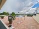 Community pool area surrounded by brick pavers and lush landscaping at 700 Mirror Nw Ter # 702, Winter Haven, FL 33881
