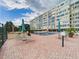 Relaxing pool area with lounge chairs and umbrellas in front of the building's exterior at 700 Mirror Nw Ter # 702, Winter Haven, FL 33881