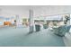 Spacious recreation room with ample seating, tables, piano, and beautiful natural light at 700 Mirror Nw Ter # 702, Winter Haven, FL 33881