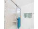 Modern shower with clear sliding door, neutral tile, and convenient in-shower seating, providing a spa-like experience at 700 Mirror Nw Ter # 702, Winter Haven, FL 33881