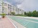 Outdoor shuffleboard courts with a backdrop of the building's architecture and landscaping at 700 Mirror Nw Ter # 702, Winter Haven, FL 33881