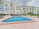 Community swimming pool with an adjacent multi-story condo building at 700 Mirror Nw Ter # 702, Winter Haven, FL 33881