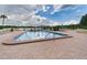 Outdoor swimming pool with patio, lounge chairs, and water view at 700 Mirror Nw Ter # 702, Winter Haven, FL 33881