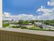 City view featuring lush trees, various rooftops, and gorgeous skies at 700 Mirror Nw Ter # 702, Winter Haven, FL 33881