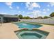Backyard featuring a pool, jacuzzi, patio, and fenced in perimeter at 704 Butternut Pl, Lakeland, FL 33813