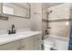 Bathroom featuring a modern vanity with sink and shower over tub at 704 Butternut Pl, Lakeland, FL 33813
