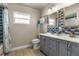Bathroom featuring a double sink vanity with decorative mirrors and blue accent wall at 704 Butternut Pl, Lakeland, FL 33813
