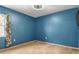 Empty bedroom with a small window, blue walls, carpet floor, and a ceiling fan at 704 Butternut Pl, Lakeland, FL 33813