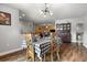 Cozy dining room with hardwood floors and a charming chandelier at 704 Butternut Pl, Lakeland, FL 33813