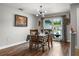 Dining room with hardwood floors, a view of front yard and ample seating at 704 Butternut Pl, Lakeland, FL 33813