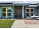 Close-up view of the front door, walkway, and front lawn at 704 Butternut Pl, Lakeland, FL 33813