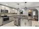 Bright eat-in kitchen features stainless steel appliances and center island with wine cooler at 704 Butternut Pl, Lakeland, FL 33813