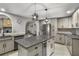 Bright eat-in kitchen features stainless steel appliances and center island with wine cooler at 704 Butternut Pl, Lakeland, FL 33813