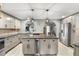 Bright eat-in kitchen features stainless steel appliances and center island with wine cooler at 704 Butternut Pl, Lakeland, FL 33813