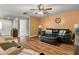 Bright living room featuring comfortable seating and hardwood floors at 704 Butternut Pl, Lakeland, FL 33813