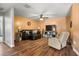 Inviting living room with hardwood floors, fan, and comfortable seating at 704 Butternut Pl, Lakeland, FL 33813