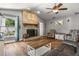 Cozy living room features brick fireplace and wood flooring at 704 Butternut Pl, Lakeland, FL 33813
