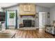 Cozy living room features brick fireplace at 704 Butternut Pl, Lakeland, FL 33813