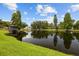 Picturesque pond view with a gazebo and lush greenery, offering a serene and natural landscape at 704 Butternut Pl, Lakeland, FL 33813