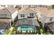 Back aerial view of the home showcasing a screened-in pool and well-manicured backyard at 7247 Oakmoss Loop, Davenport, FL 33837