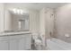 Bathroom featuring a vanity, toilet and shower/tub combination with tiled surround at 7247 Oakmoss Loop, Davenport, FL 33837