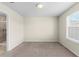 Bright bedroom features neutral walls, carpet flooring, and a window for natural light at 7247 Oakmoss Loop, Davenport, FL 33837