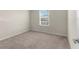 Bedroom featuring neutral carpet and walls, with a window providing natural light at 7247 Oakmoss Loop, Davenport, FL 33837