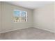 Neutral bedroom with tile floor, window with blinds, and bright natural light at 7247 Oakmoss Loop, Davenport, FL 33837