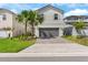 Charming two-story home with a brick paved driveway and well-maintained landscaping at 7247 Oakmoss Loop, Davenport, FL 33837