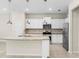 Spacious kitchen features white cabinets, stainless steel appliances, and a large island at 7247 Oakmoss Loop, Davenport, FL 33837