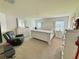Relaxing primary bedroom offers natural light, neutral walls, and a dresser with an ornate framed mirror at 737 Daphne Dr, Polk City, FL 33868